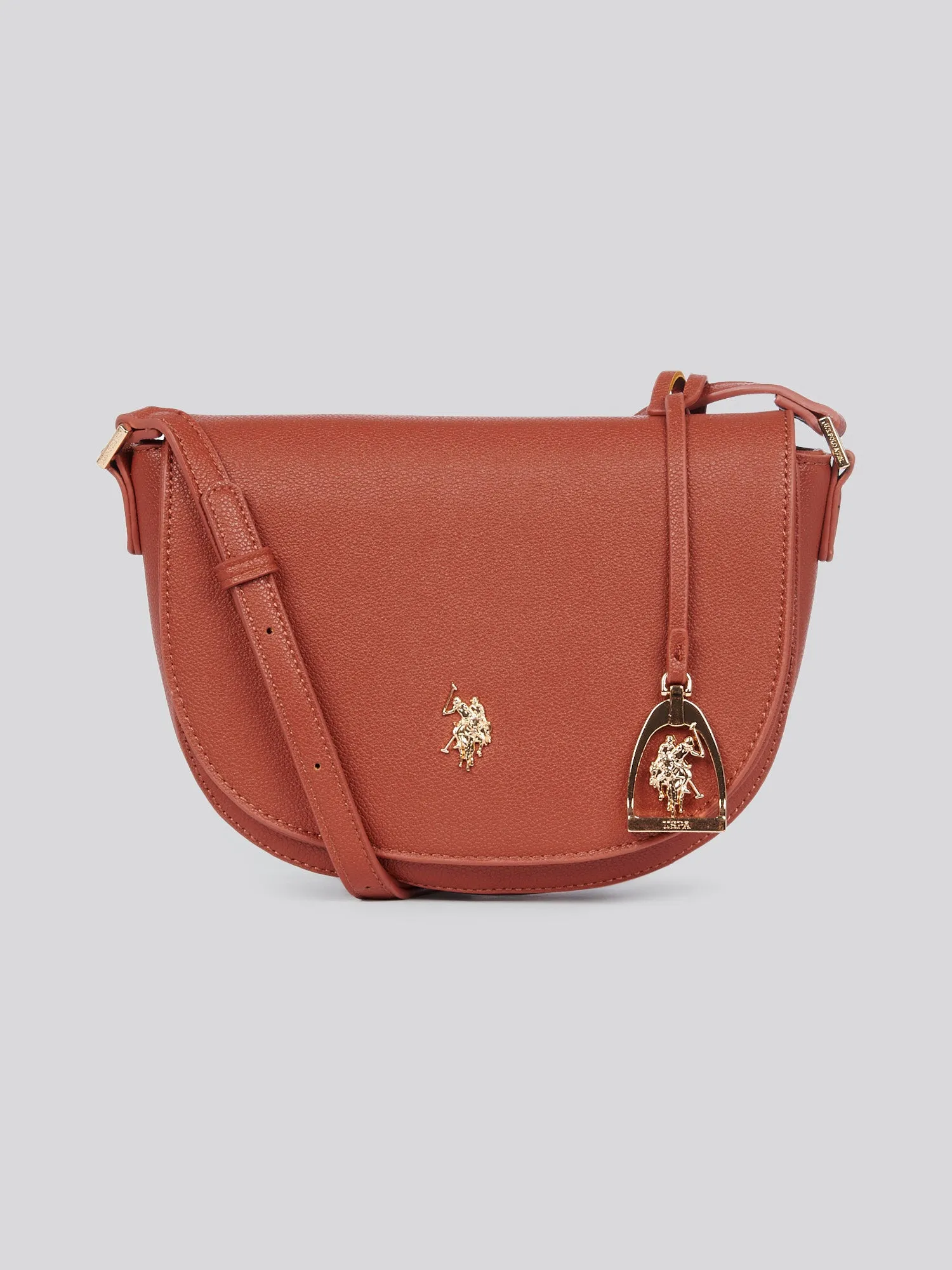 U.S. Polo Assn. Womens Jones Flap Crossbody Bag in Rust